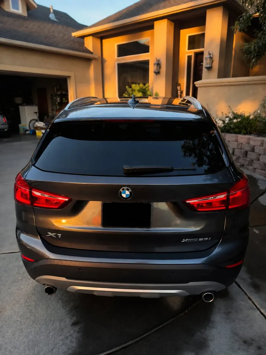 Glossy tailgate of a detailed BMW X1 at sunset